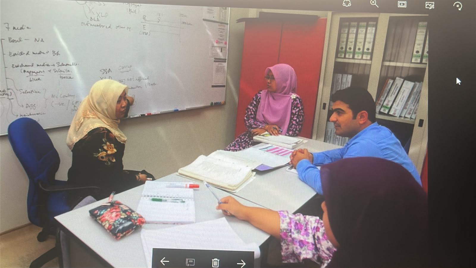 A small group reviewing training materials