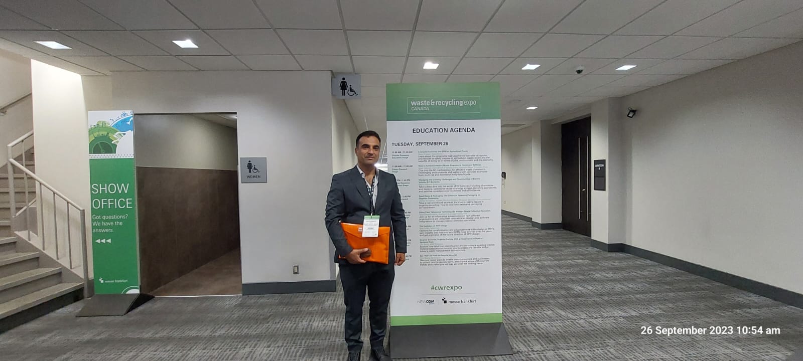 Visitor beside the education agenda at Waste and Recycling Expo Canada